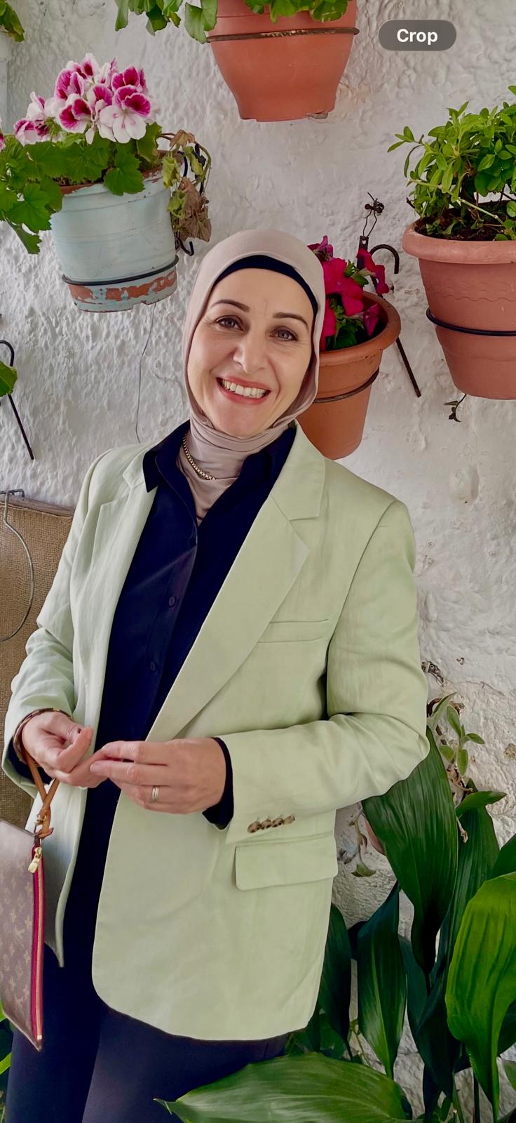 Crescent Consulting Group team member smiling in a bright, plant-filled space